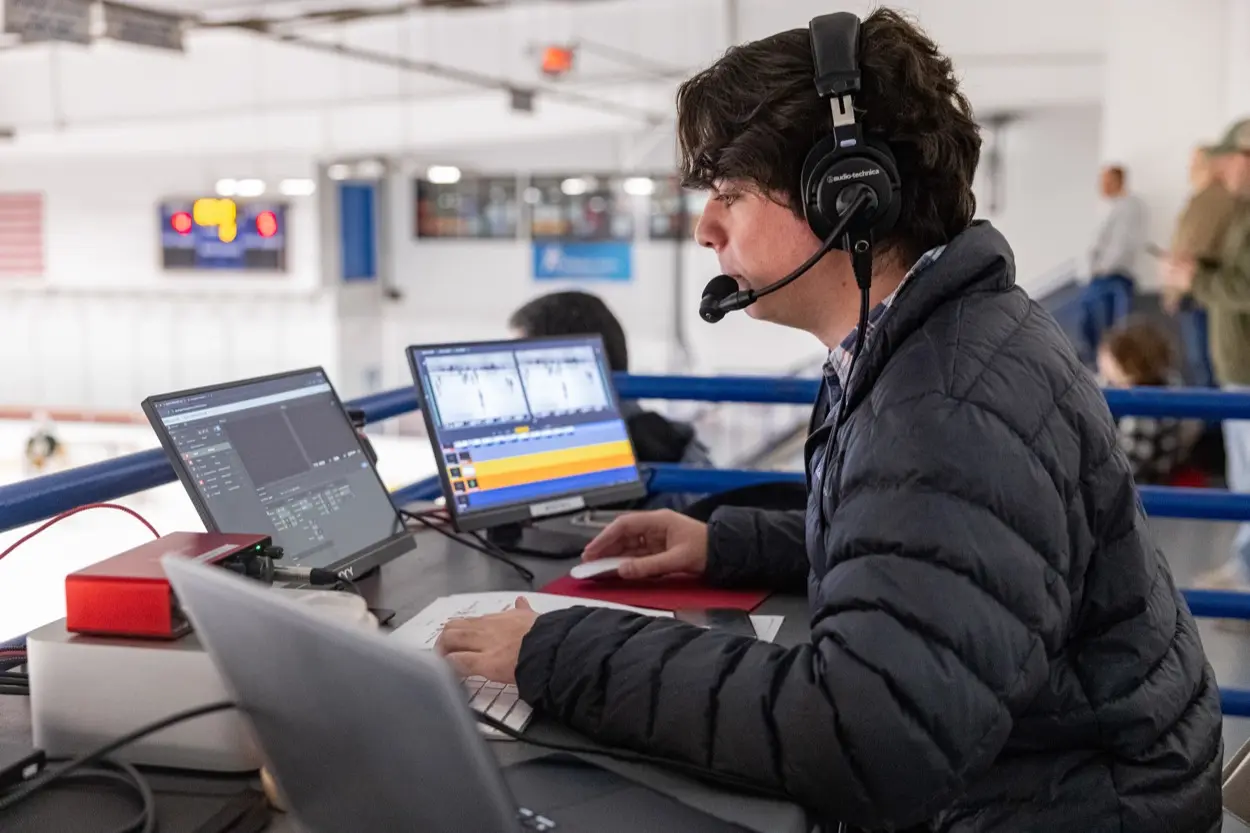LI Sports Network commentator calling a game from the broadcast position
